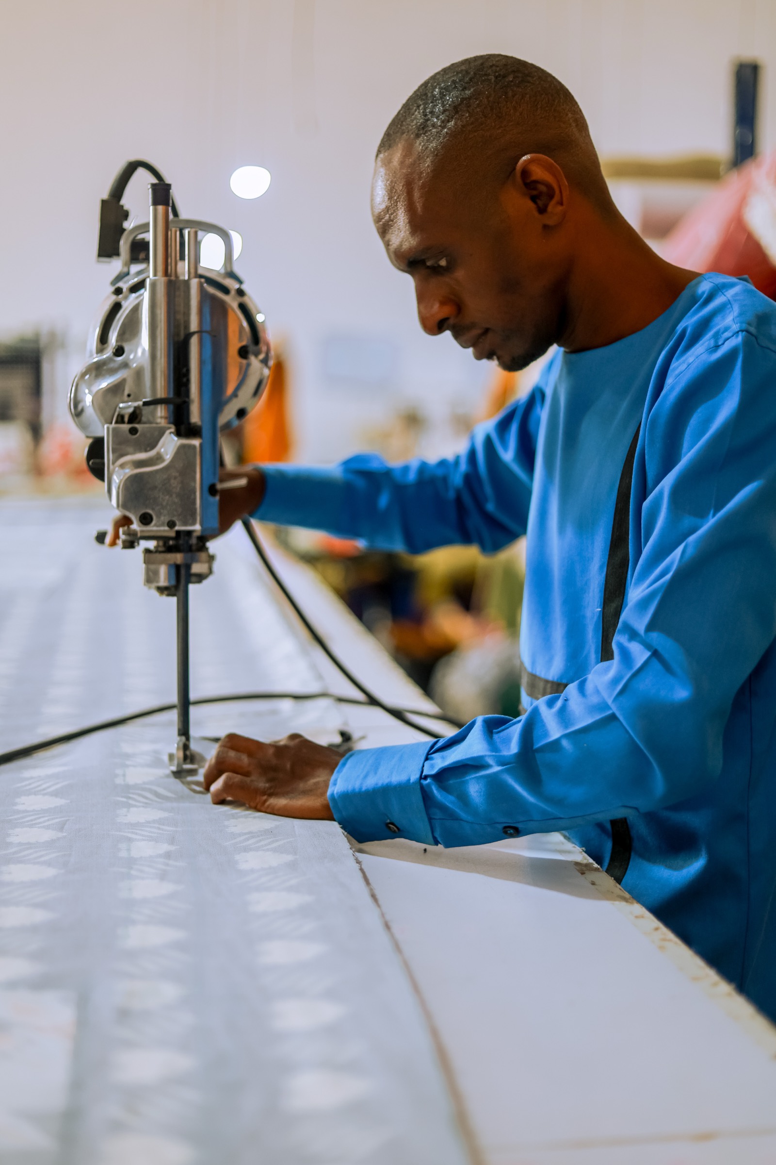 Cutting fabric at the Waya Collective factory
